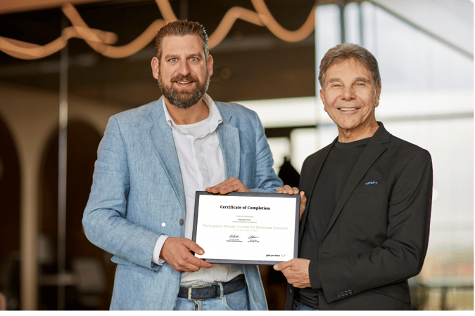 Cialdini and Bas holding certificate