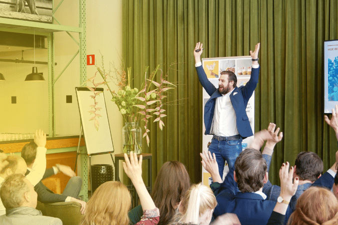 Bas smiling on stage with a small group - 1000x667