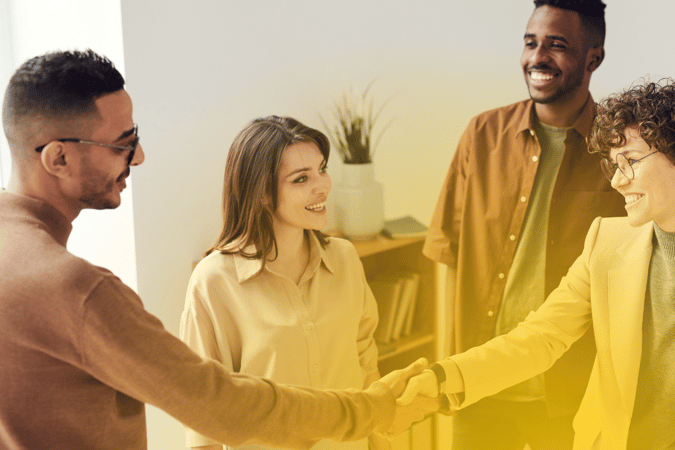 Team shaking hands at work 1000 x 667